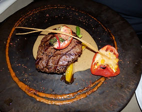Two Chefs - Pepper steak with a creamy brandy pepper sauce, baked tomato, sauteed vegetables & potato gratin.